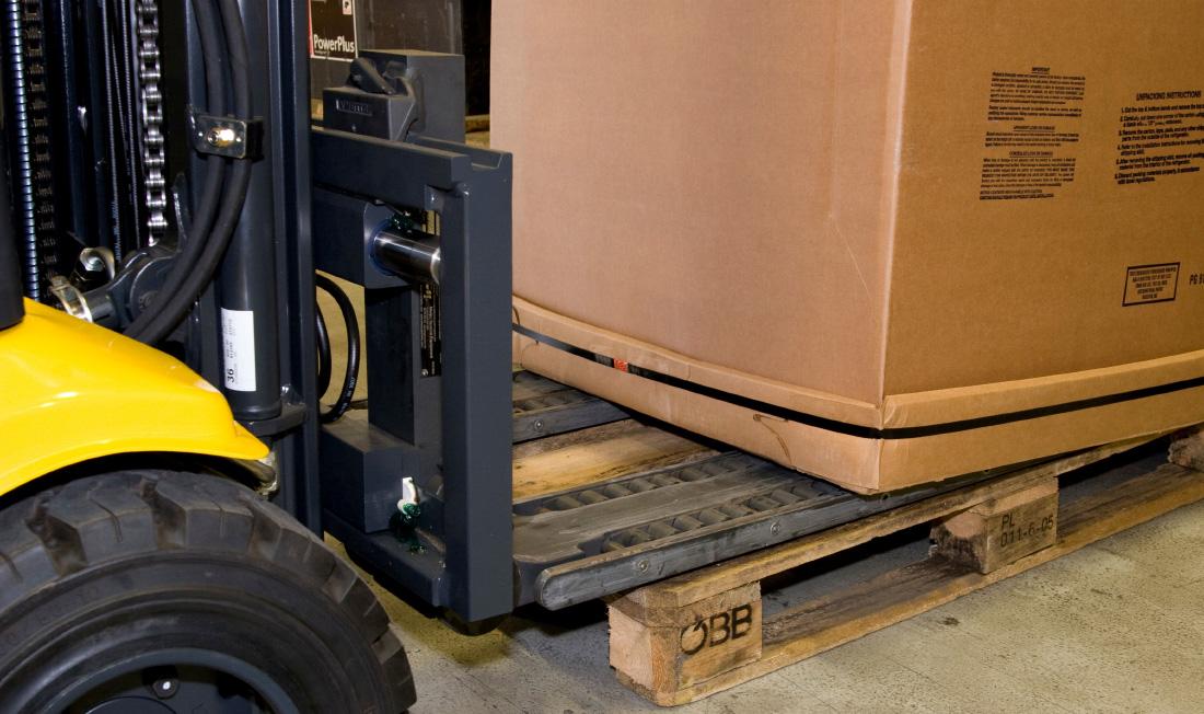 Cascade-Kooi Rollerforks slip between a pallet and corrugated carton load for pallet and pallet-less handling.